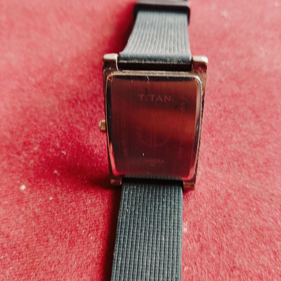 Titan Edge analog tank watch features a sleek rectangular case and a minimalist white dial. — photo 2 of 2